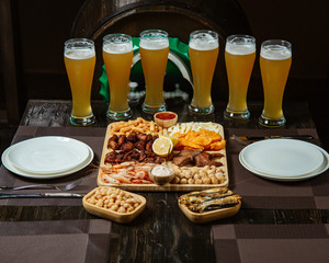 beer set with multiple snacks and lots of beer