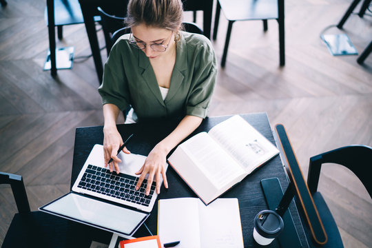 Young student doing classwork at table