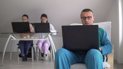 Parents and children all working from home in pyjamas during corona covid 19 quarantine. Social distancing prevvention from virus spread