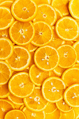 Bright orange background with slices of juicy oranges. Orange in the section. Orange-abstract fruit background, natural vitamins. Backgrounds and textures