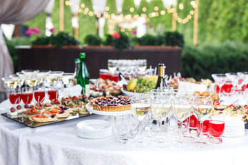 the wedding ceremony is decorated with flower arrangements and candle stands in a country restaurant