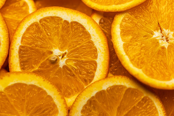 Bright orange background with slices of juicy oranges. Orange in the section. Orange-abstract fruit...