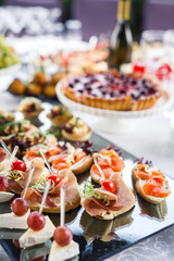 on a wooden table in the wedding banquet area are snacks, fruits, sweet cakes and muffins and lemonade drink