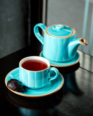 black cookie and cup of black tea