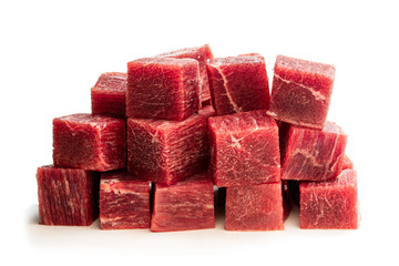 Cubes of raw beef meat isolated on white