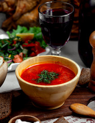 borsch with herbs and glass of wine