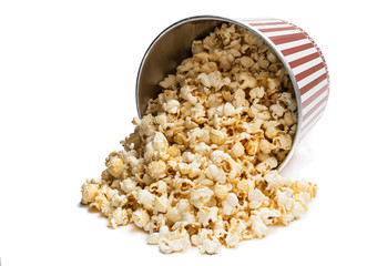 Scattered big bucket of popcorn isolated on white