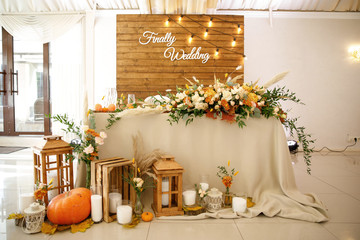 banquet table is decorated with plates, cutlery, glasses, candles and flower arrangements