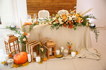 banquet table is decorated with plates, cutlery, glasses, candles and flower arrangements