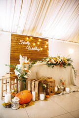 banquet table is decorated with plates, cutlery, glasses, candles and flower arrangements