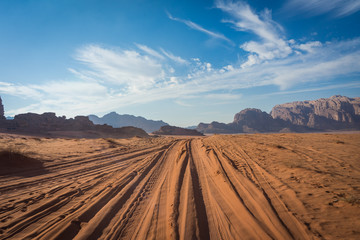 desert road in wadi rum, jeep traces in the sand
