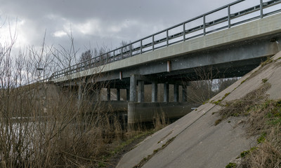 concrete bridge over the river, spring day