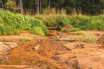 The stream flows along the river bank