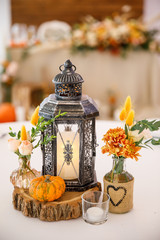 banquet table is decorated with plates, cutlery, glasses, candles and flower arrangements