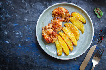 fried chicken and potatoes, keto or paleo diet menu concept food background. top view. copy space for text