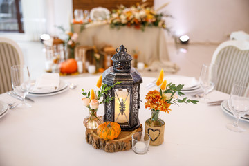 banquet table is decorated with plates, cutlery, glasses, candles and flower arrangements