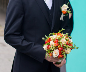 Groom with a bouquet awaits the bride