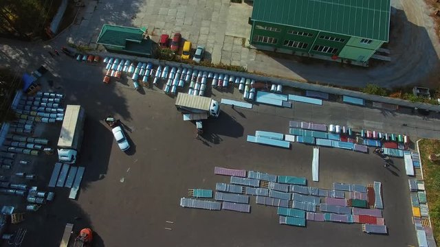 Aerial view of warehouse storages. Large storage of construction materials in industrial city zone from above