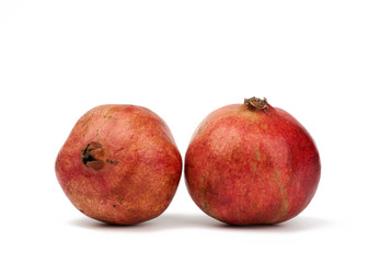 round red ripe pomegranate fruit in peel isolated on a white background, close up
