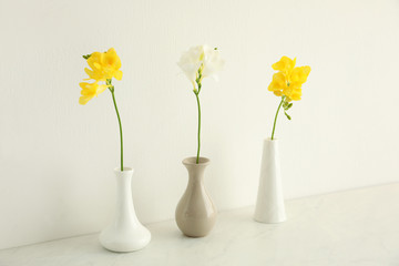 Beautiful freesia flowers on white marble table