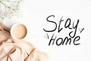 Obraz premium Stay home stay safe concept. Top view coffee cup, blanket and message 