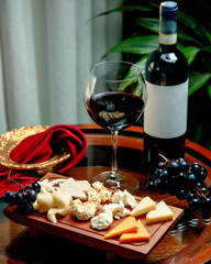 cheese set with winegrape and glass of wine