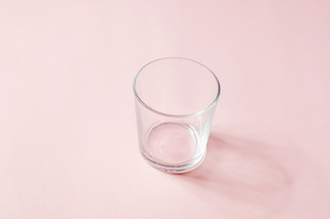 empty glass on a light pink background