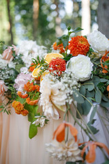banquet table is decorated with plates, cutlery, glasses, candles and flower arrangements