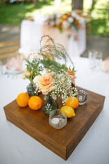 banquet table is decorated with plates, cutlery, glasses, candles and flower arrangements