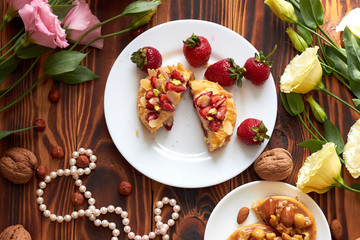 Сut mini tart cupcake with strawberries on plate. Close up.