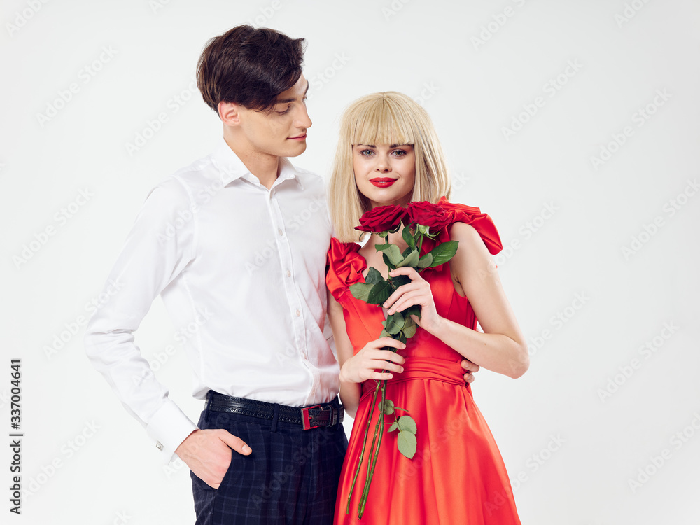 Wall mural happy young couple with red rose