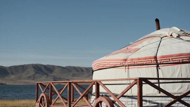 lonely Yurt in a picturesque place in Mongolia on shore of beautiful lake,remote and wild place steppe,in distant mountains altai