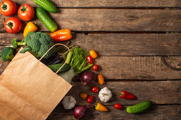 Exposition of fresh organic vegetables on wooden table. tomato, pepper, broccoli, onion, garlic, cucumber,  eggplant, black Eyed Peas, ecological bag.
