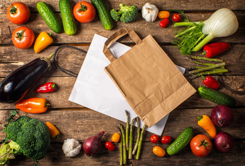 Exposition of fresh organic vegetables on wooden table. tomato, pepper, broccoli, onion, garlic, cucumber,  eggplant, black Eyed Peas, ecological bag.