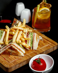club sandwich with fries and single tomato