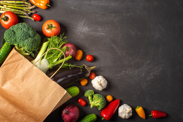 Exposition of fresh organic vegetables on black table. tomato, pepper, broccoli, onion, garlic, cucumber,  eggplant, black Eyed Peas, ecological bag.