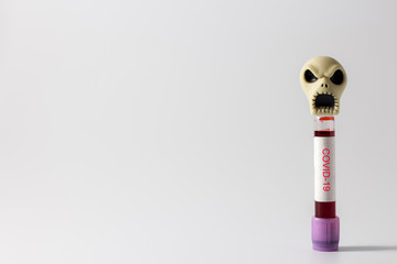 Coronavirus disease COVID-19 infection can cause death,COVID-19 blood sample test tube and skull on...