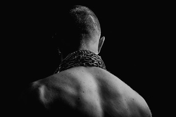 Pumped athlete's back. Back. Chain on back. Sport. Black and white background. In the hands of chains. Sport is our everything. Shoulders.
