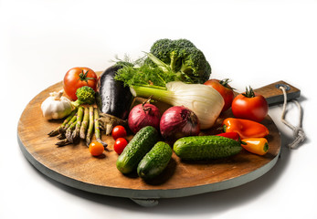 Exposition of fresh organic vegetables on wooden plate. tomato, pepper, broccoli, onion, garlic, cucumber,  eggplant, black Eyed Peas, ecological bag.