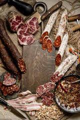 Set of smoked and dried meat ham, jerky, salted biltong meat, spices and herbs