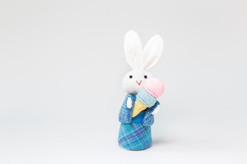 Rabbit with ice cream, white fabric rabbit with traditional blue Japanese dress holding ice cream isolate on white backgrouond