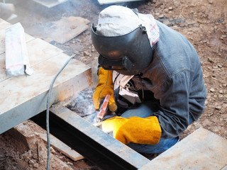 Welding work ,worker with protective welding metal on construction