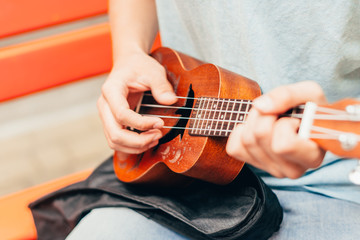 man playing on ukulele