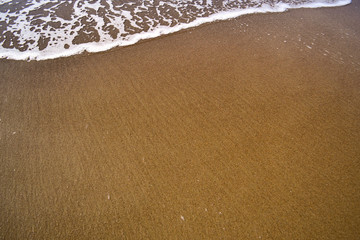 Fototapeta na wymiar sandy beach and waves on a Sunny summer day. Copy space.