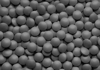 Lots of gray round frosted tablets