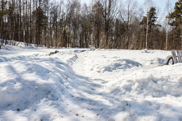 Old tires from cars and trees. Paintball territory in the forest. Background for advertising