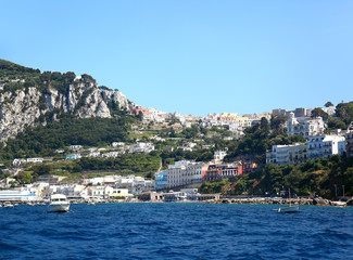 Fototapeta na wymiar Capri, Italy: Panoramic view from the Marina Grande to the town in the hills up above.