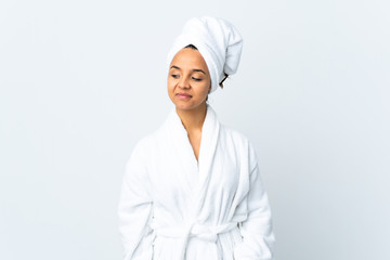 Young woman in bathrobe over isolated white background having doubts while looking side