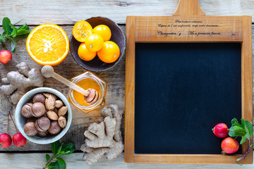 Healthy products for Immunity boosting on wooden background with copy space top view. Lemon, nuts, ginger to immune system