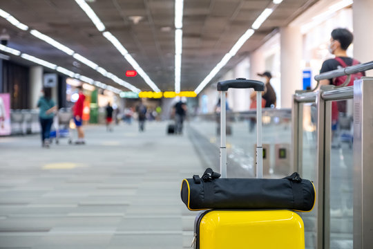Close up luggage with blurred airport background in airport in corona virus situation